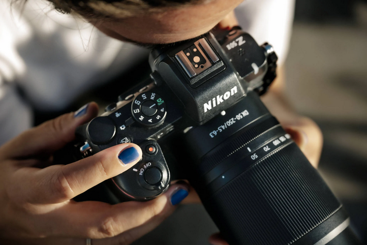 person looking true the viewfinder of the new Nikon Z50II